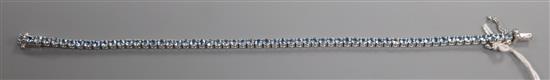 A 750 white metal and aquamarine set line bracelet, 18.2cm.